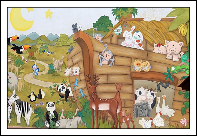 A cartoon picture of Noah’s Ark run aground on a green landscape with pairs of animals all around it.